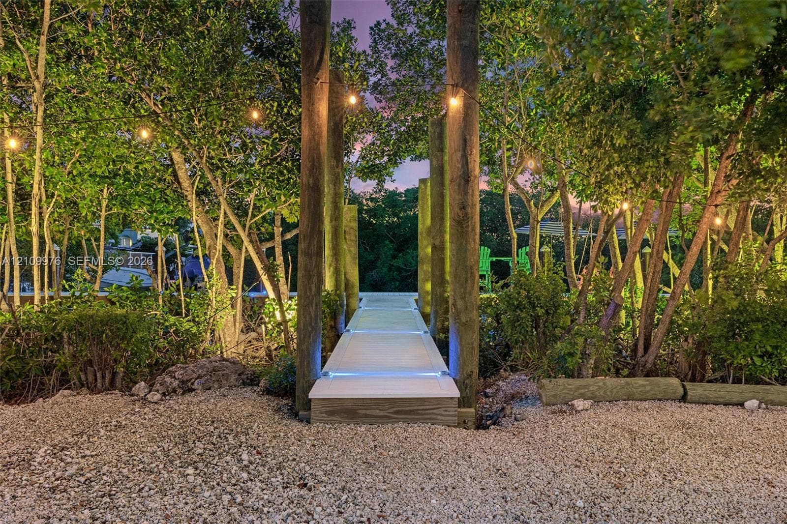 43 Waterways Drive, Key Largo, FL 33037 Gravel surface ground cover, wooden support pilings, elevated composite walkway, and integrated path lighting