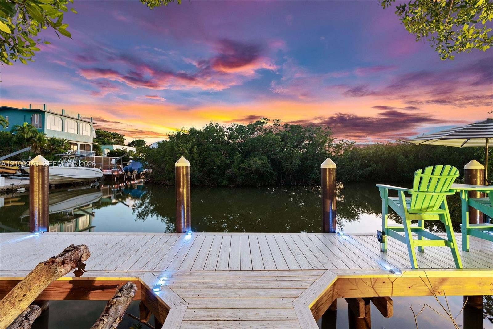 43 Waterways Drive, Key Largo, FL 33037 Waterfront dock featuring composite decking, integrated perimeter lighting, and decorative pilings