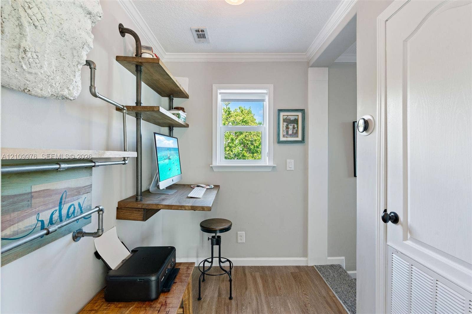 43 Waterways Drive, Key Largo, FL 33037 Built-in industrial-style shelving with wood-finish surfaces, wall-mounted desk, crown molding, and wood-finish flooring