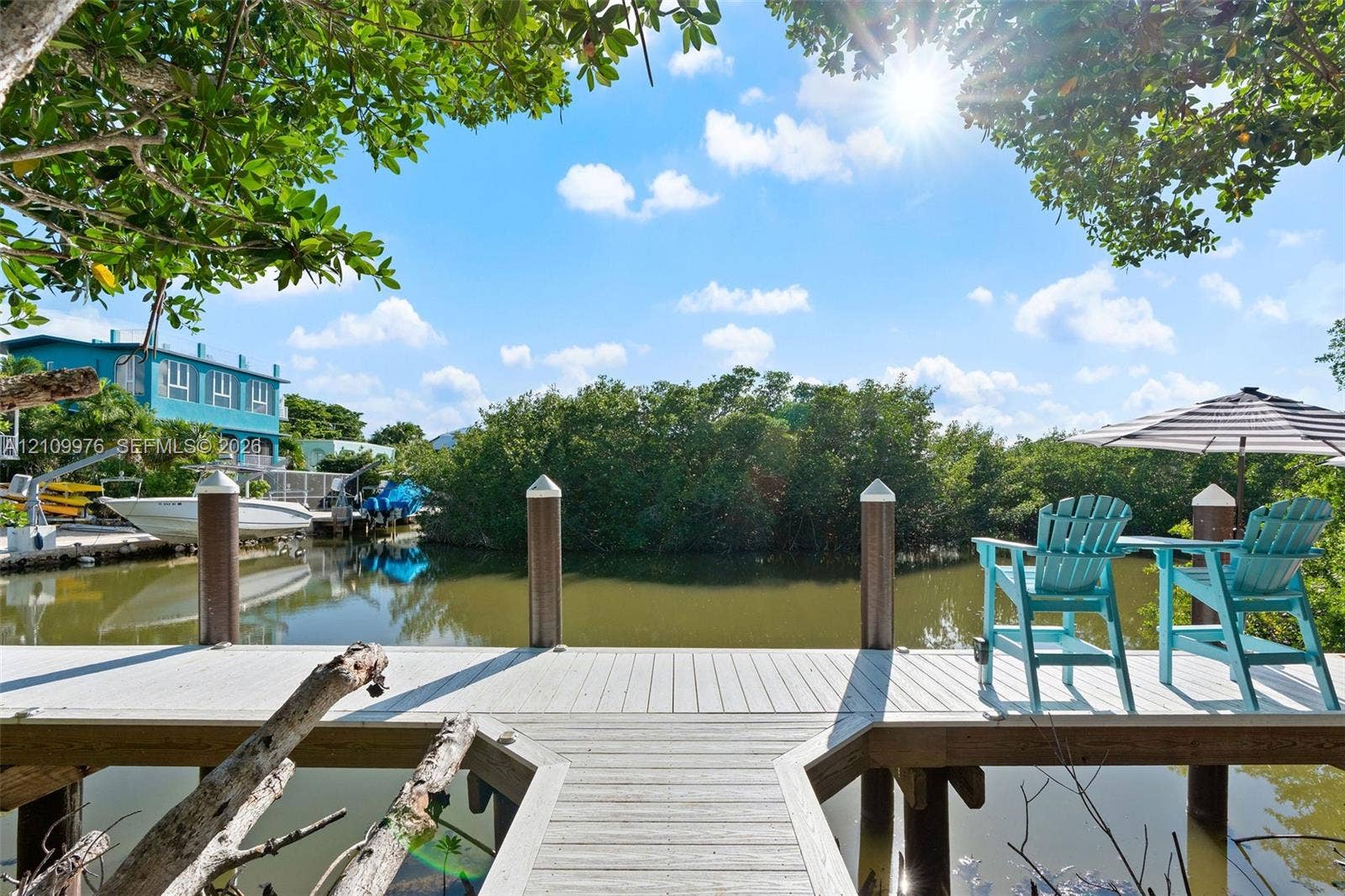43 Waterways Drive, Key Largo, FL 33037 Private wooden dock featuring structural pilings and water access
