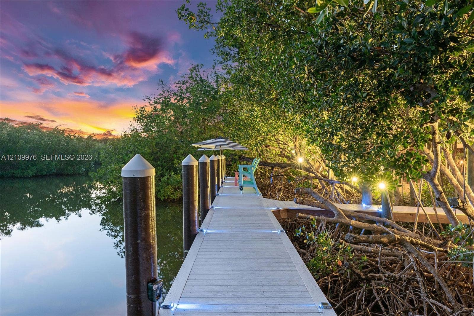 43 Waterways Drive, Key Largo, FL 33037 Waterfront dock featuring composite decking, integrated deck lighting, and structural pilings nestled among native mangrove vegetation