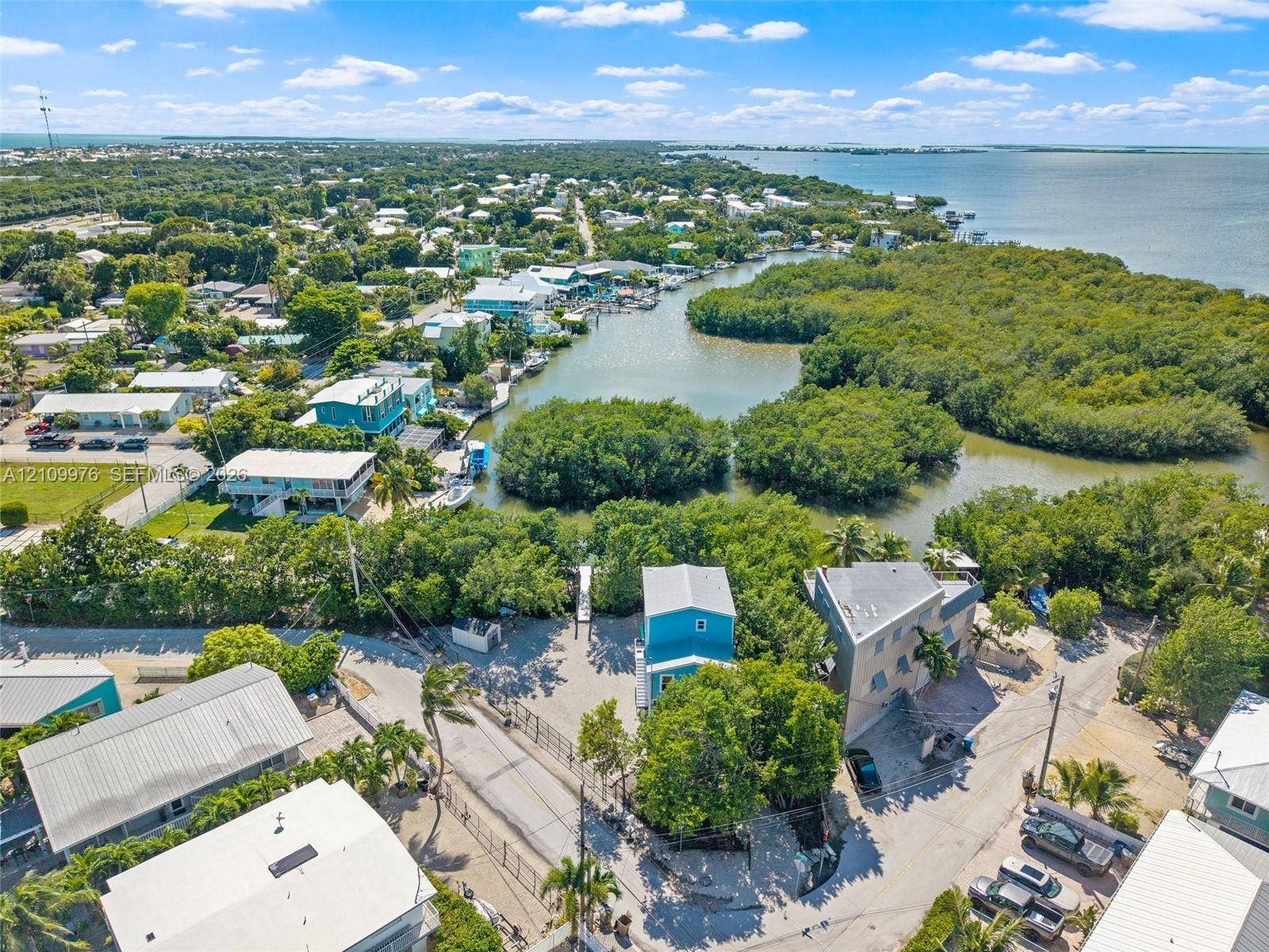 43 Waterways Drive, Key Largo, FL 33037 Aerial perspective featuring direct water frontage, established mangrove vegetation, and a coastal residential setting with paved road access