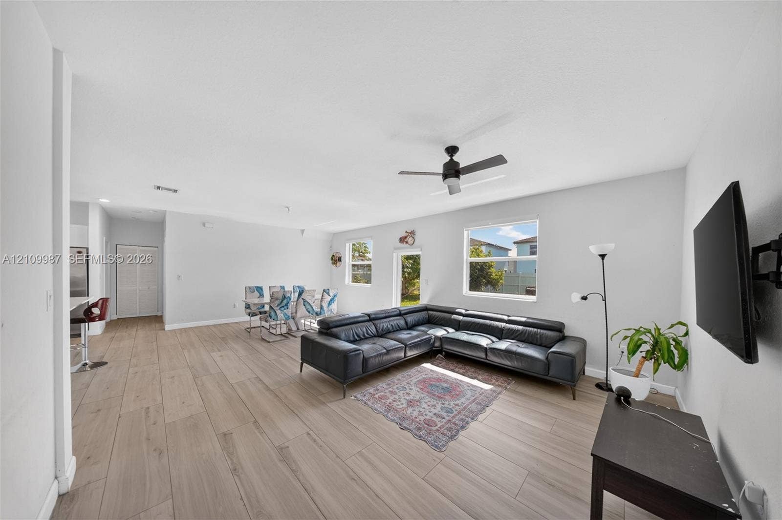 Open concept interior featuring porcelain flooring, recessed lighting, and a ceiling fan