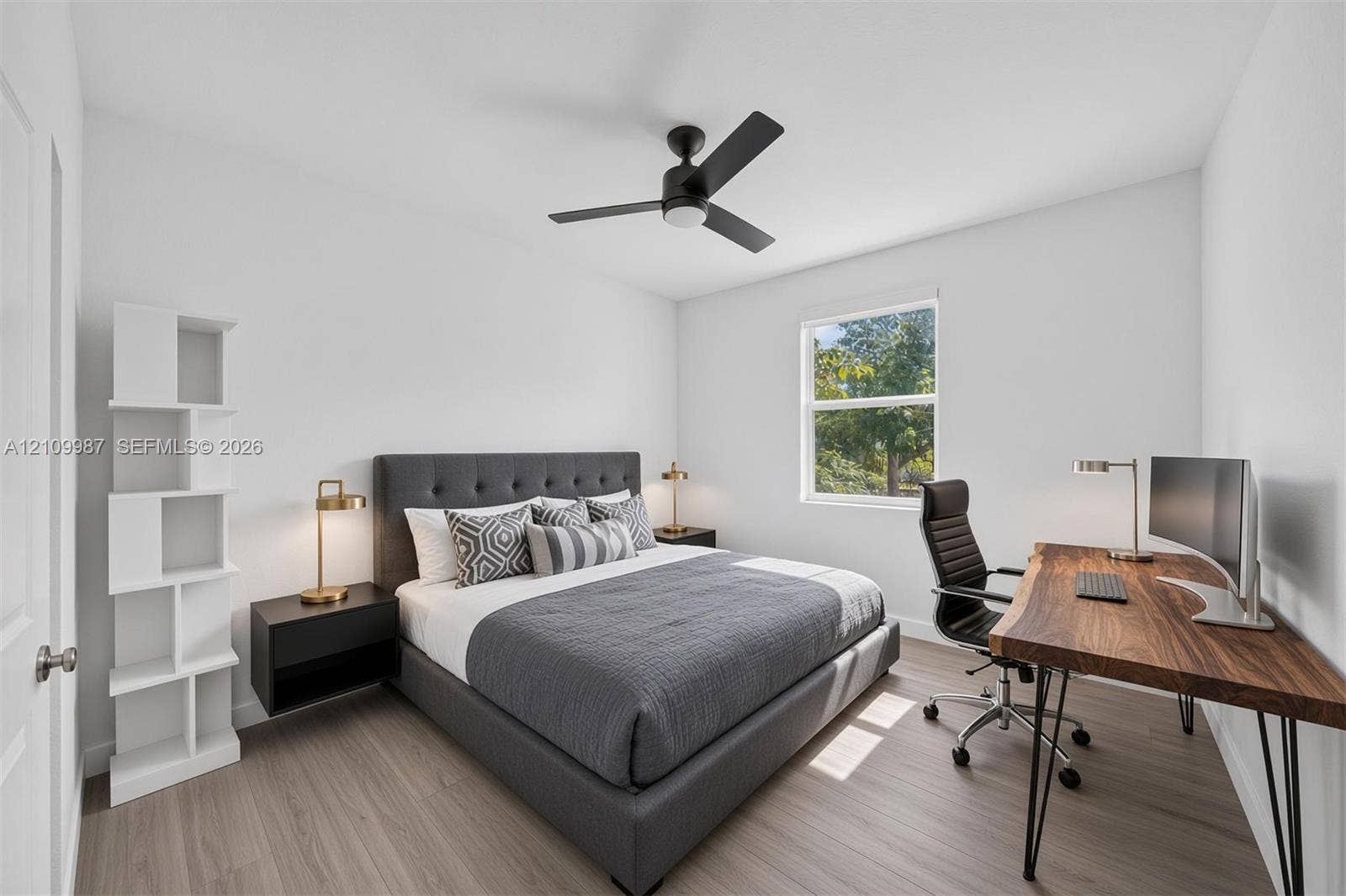 Staged Bedroom featuring porcelain flooring, a matte black ceiling fan with integrated lighting, and a single-pane window