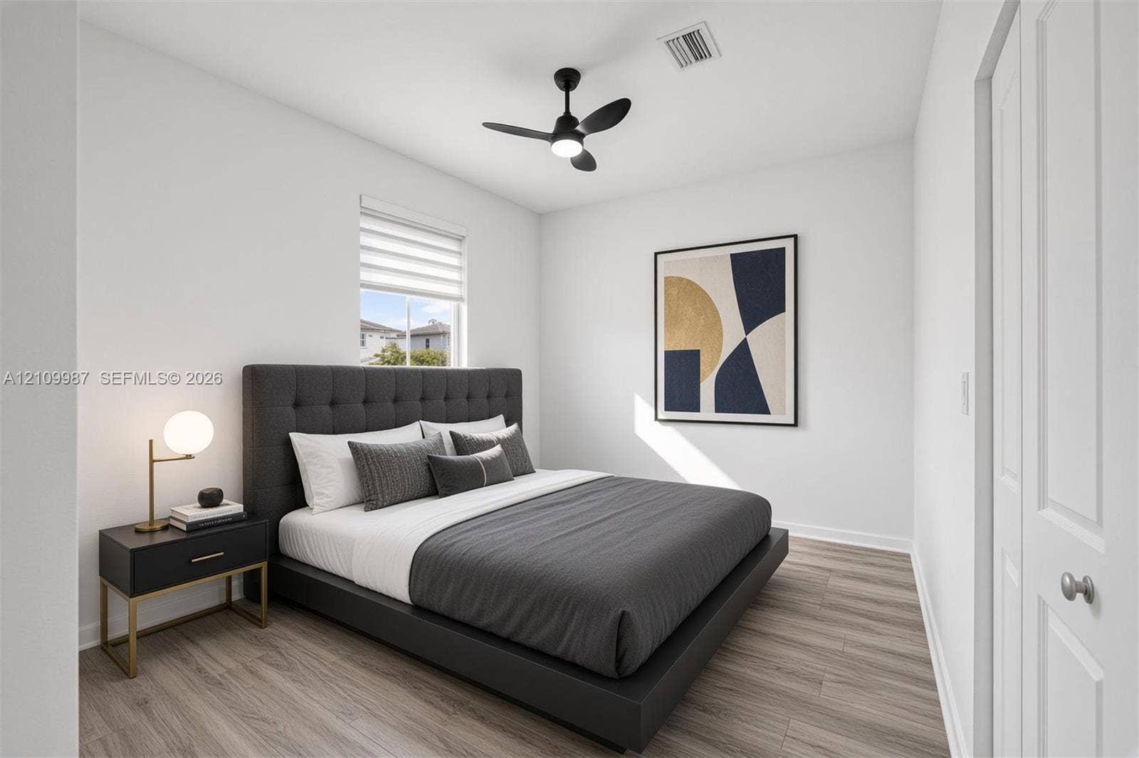 Neutral-toned interior featuring porcelain flooring, a contemporary matte black ceiling fan with integrated lighting, and a single-panel interior door