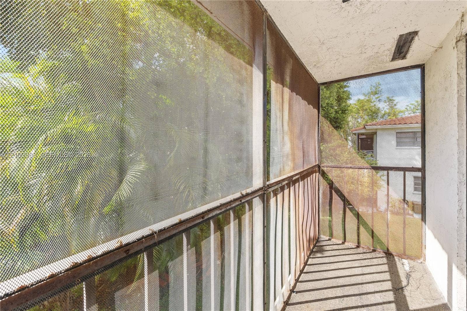 13946 NE 4th Avenue, #13946, Miami, FL 33161 Screened balcony featuring concrete flooring and metal railings