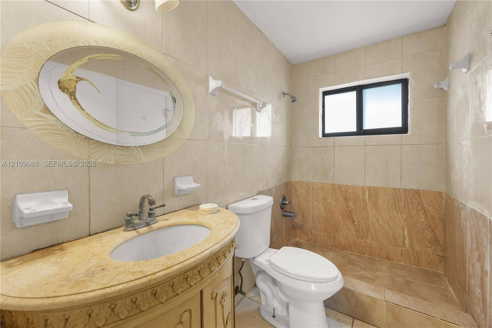 13946 NE 4th Avenue, #13946, Miami, FL 33161 Bathroom featuring neutral tile wall cladding, a vanity with a stone countertop and undermount sink, and a built-in shower enclosure