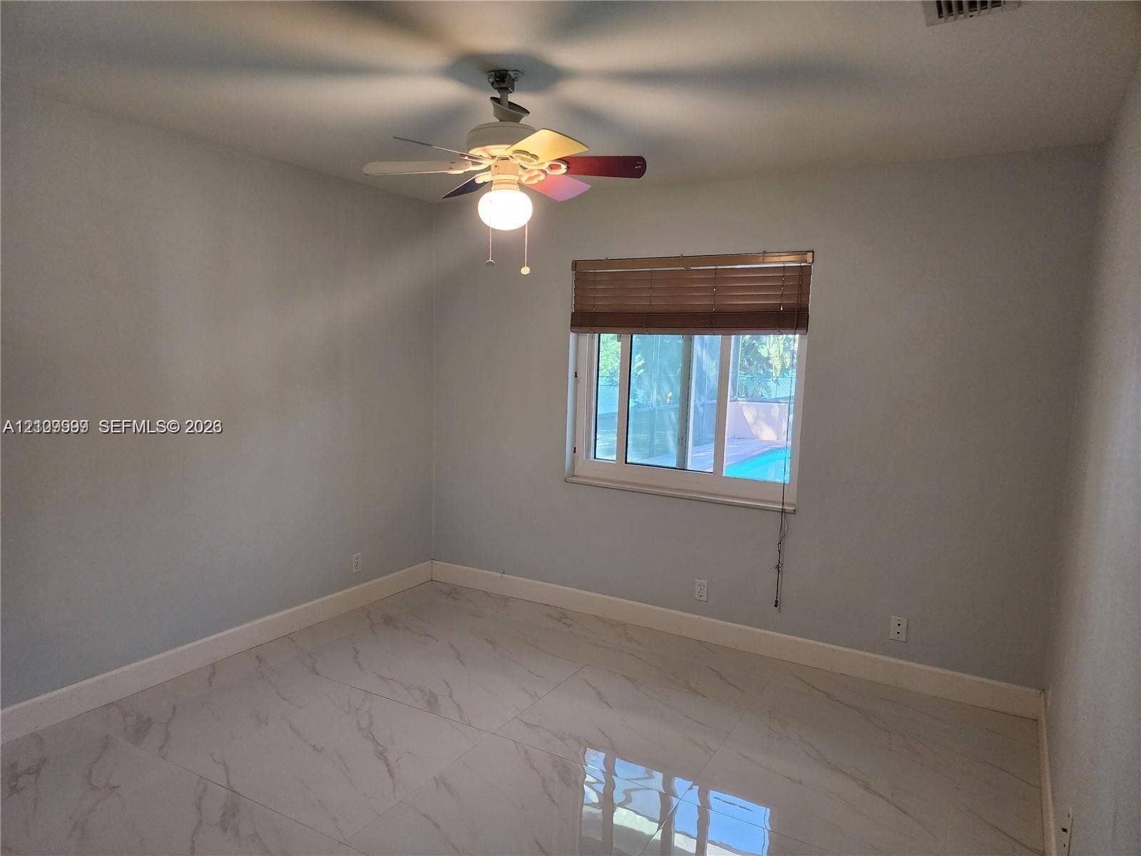 1794 NW 112th Terrace, Coral Springs, Coral Springs, FL 33071 Polished stone-finish flooring, ceiling-mounted light fixture with integrated fan, and sliding window with wood-slat blinds