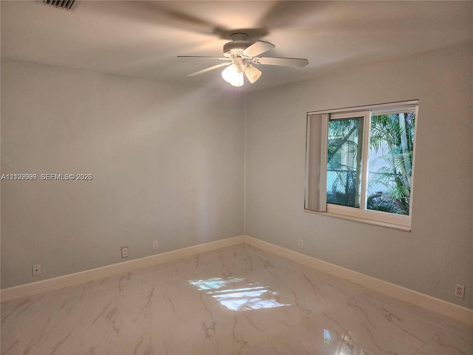 1794 NW 112th Terrace, Coral Springs, Coral Springs, FL 33071 Neutral interior featuring polished stone-finish flooring, a ceiling fan with integrated light fixture, and a sliding window
