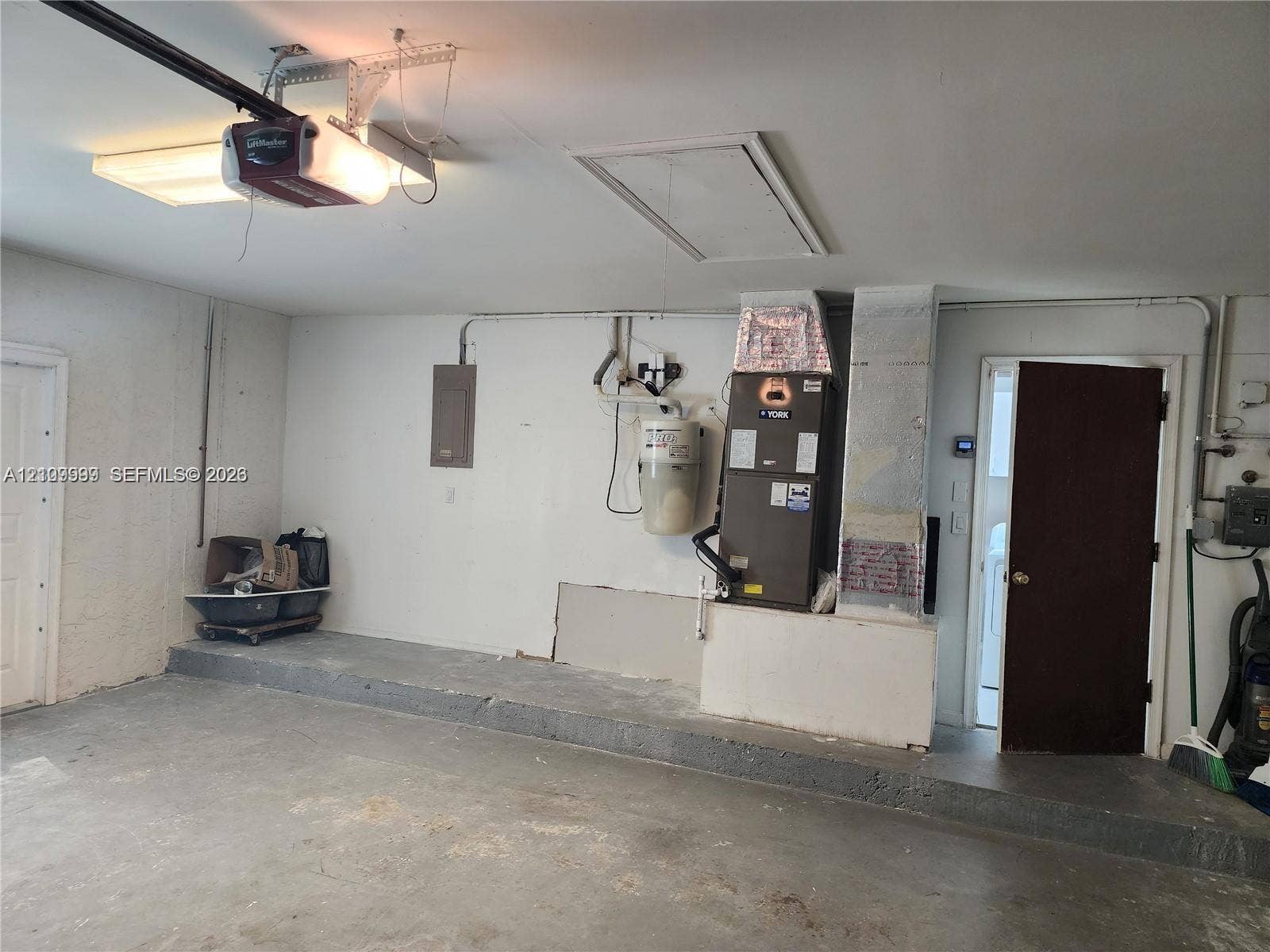 1794 NW 112th Terrace, Coral Springs, Coral Springs, FL 33071 Garage featuring concrete flooring, an overhead automatic door opener, a dedicated HVAC unit, an electrical panel, and an access door