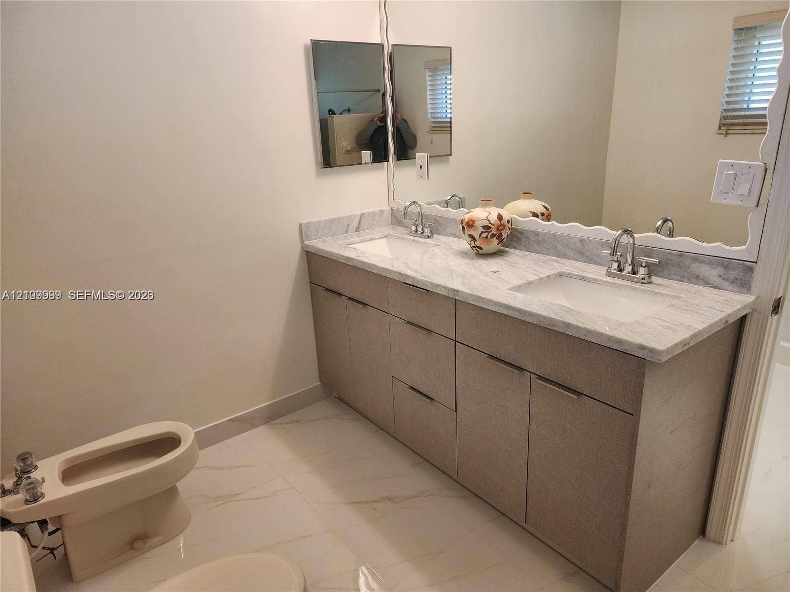 1794 NW 112th Terrace, Coral Springs, Coral Springs, FL 33071 Dual-sink vanity with stone countertop, polished chrome hardware, large vanity mirror, and light-toned tile flooring