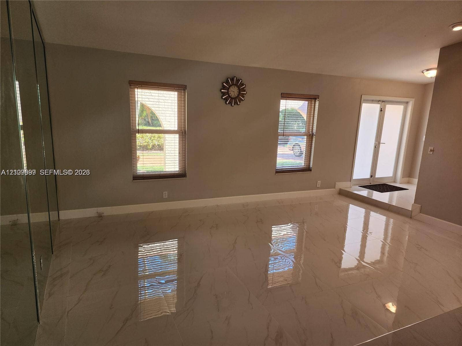 1794 NW 112th Terrace, Coral Springs, Coral Springs, FL 33071 Large-format polished tile flooring, full-height mirrored wall, double-entry glass paneled doors, and dual windows