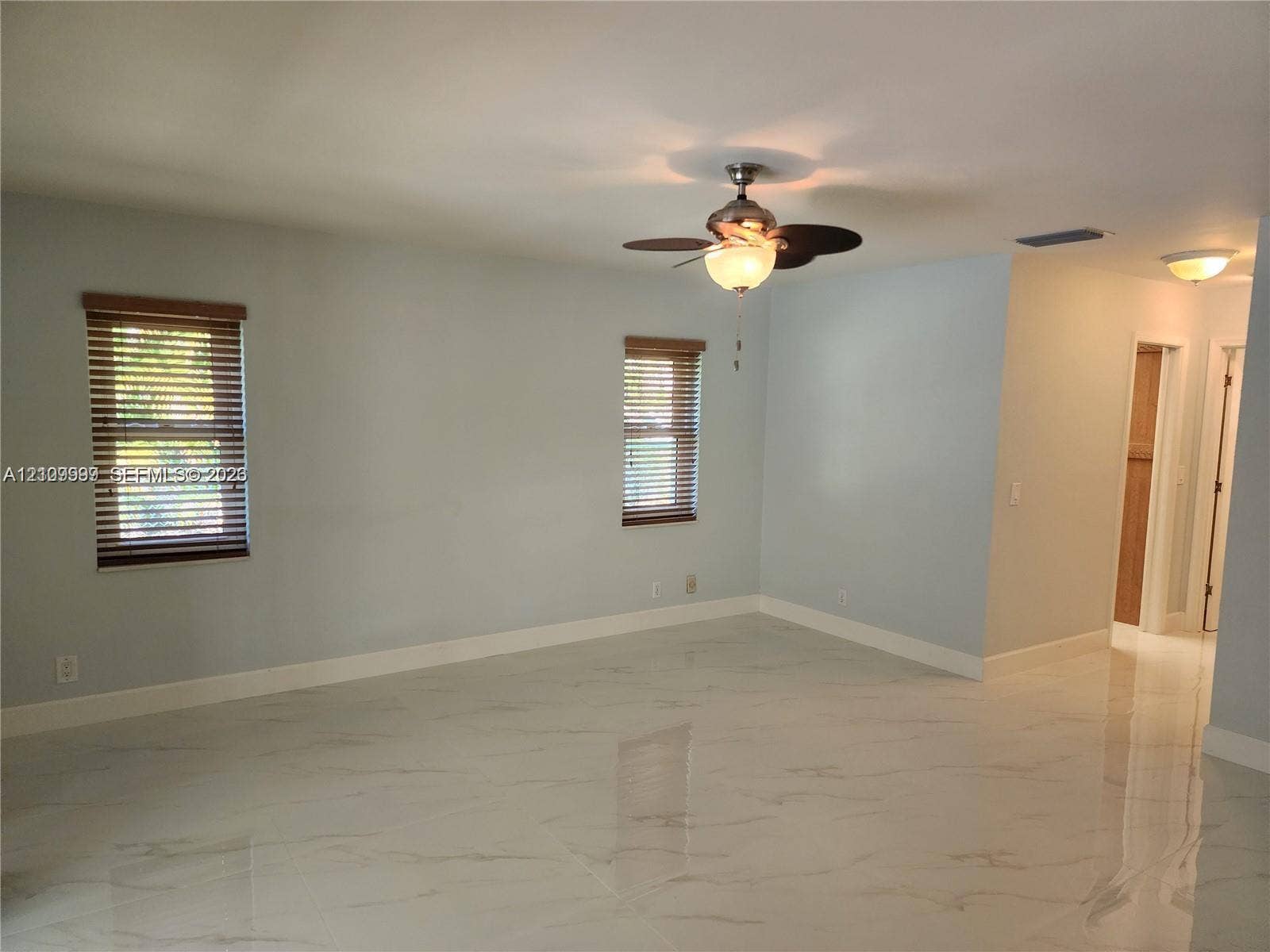 1794 NW 112th Terrace, Coral Springs, Coral Springs, FL 33071 Interior space featuring polished stone-finish flooring, recessed lighting, a ceiling fan with integrated light fixture, and horizontal blinds on windows