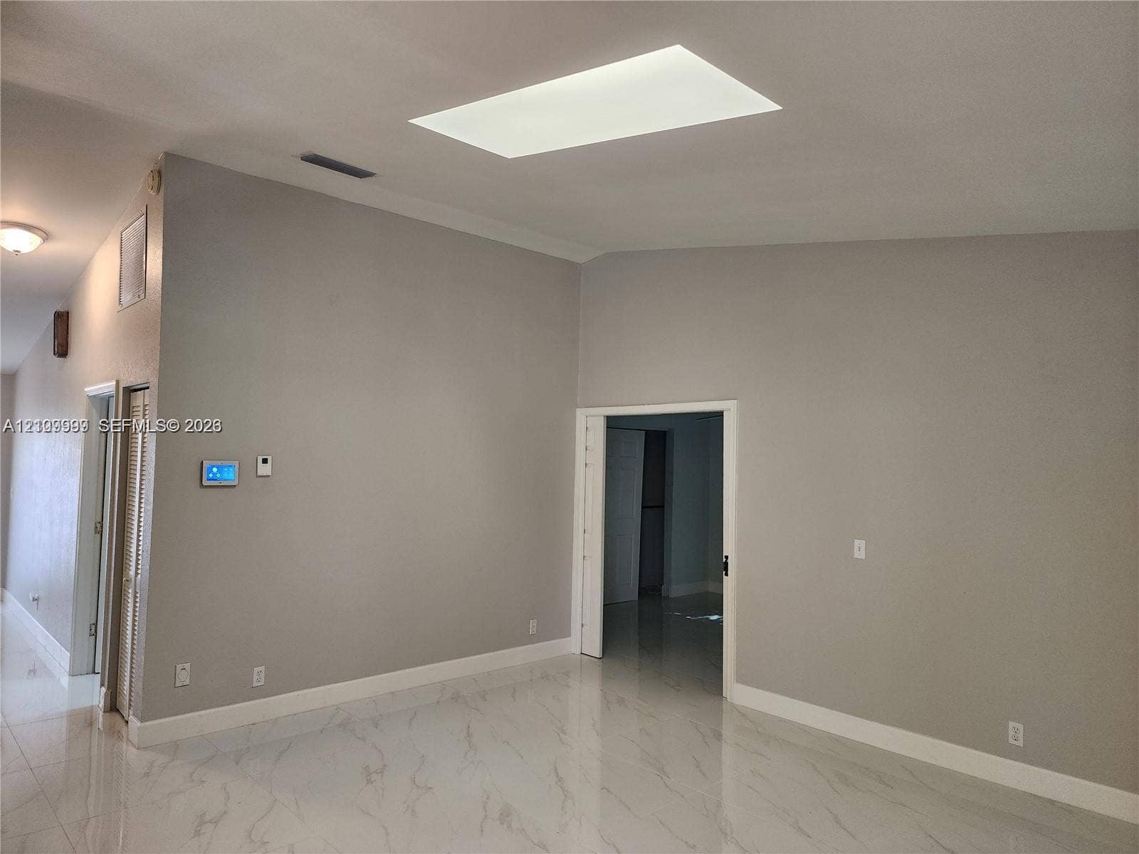 1794 NW 112th Terrace, Coral Springs, Coral Springs, FL 33071 Vaulted ceilings featuring a rectangular skylight, paired with large-format stone-finish floor tiling