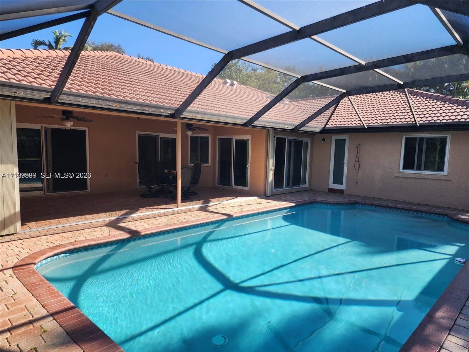 1794 NW 112th Terrace, Coral Springs, Coral Springs, FL 33071 Screened lanai featuring a tile roof, paved deck, and in-ground swimming pool