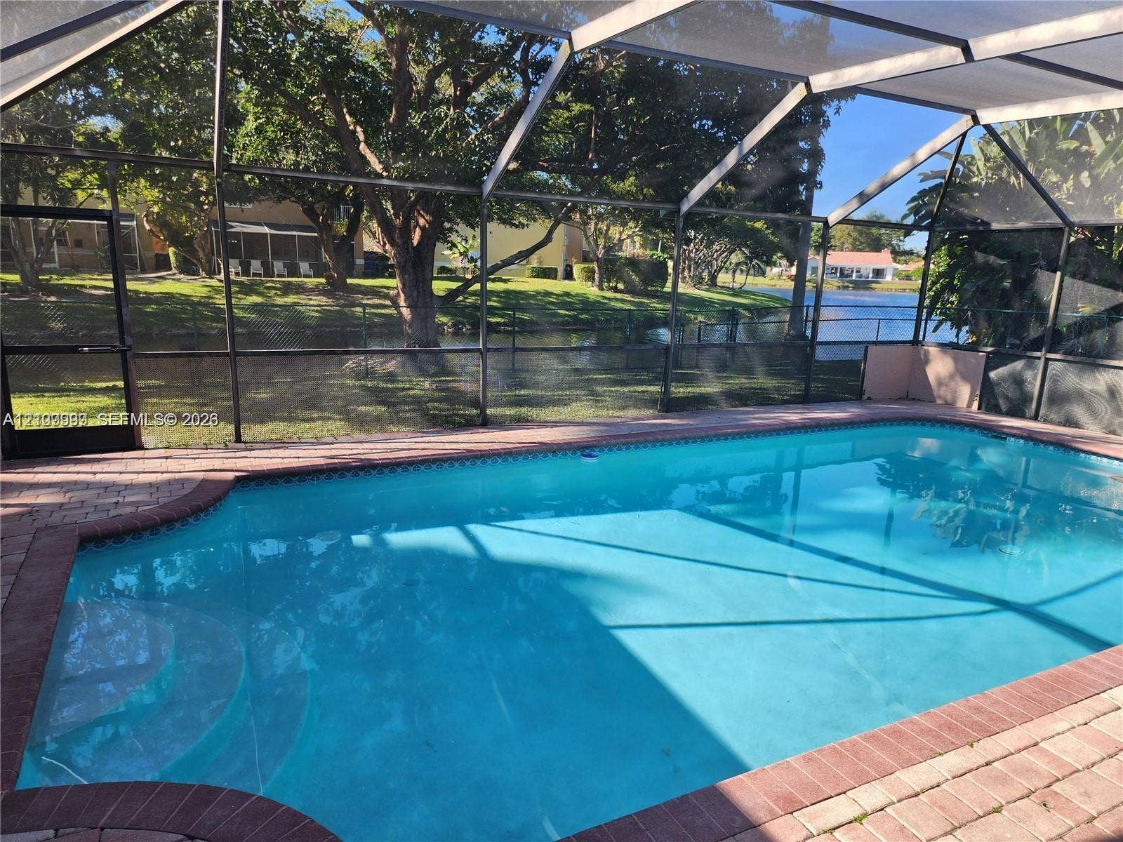 1794 NW 112th Terrace, Coral Springs, Coral Springs, FL 33071 Screened-in patio featuring a swimming pool, paver deck, and waterfront access