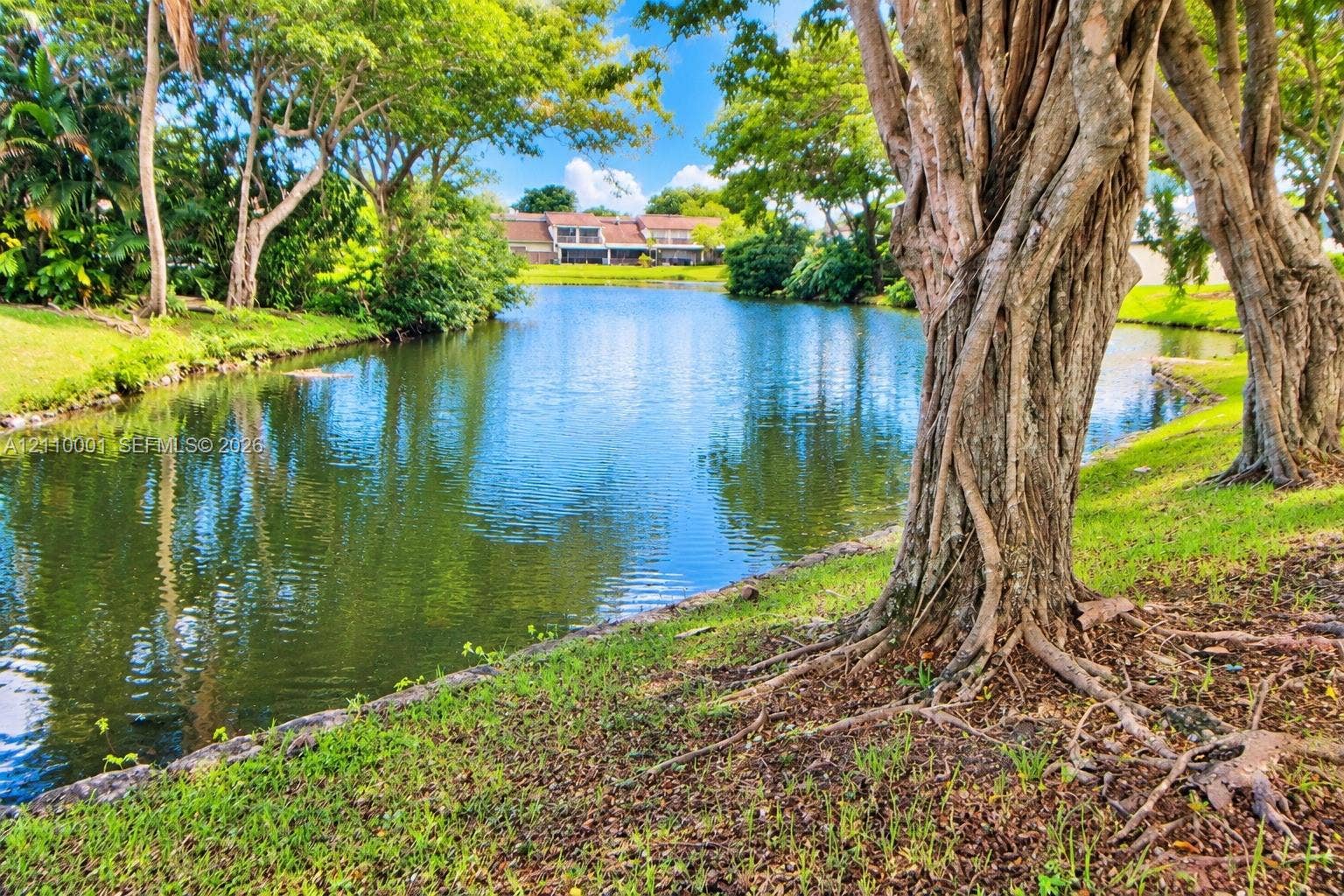 3617 SW 69th Terrace, #24-Z, Miramar, FL 33023 Waterfront lot featuring a natural pond, mature trees, and landscaped lawn