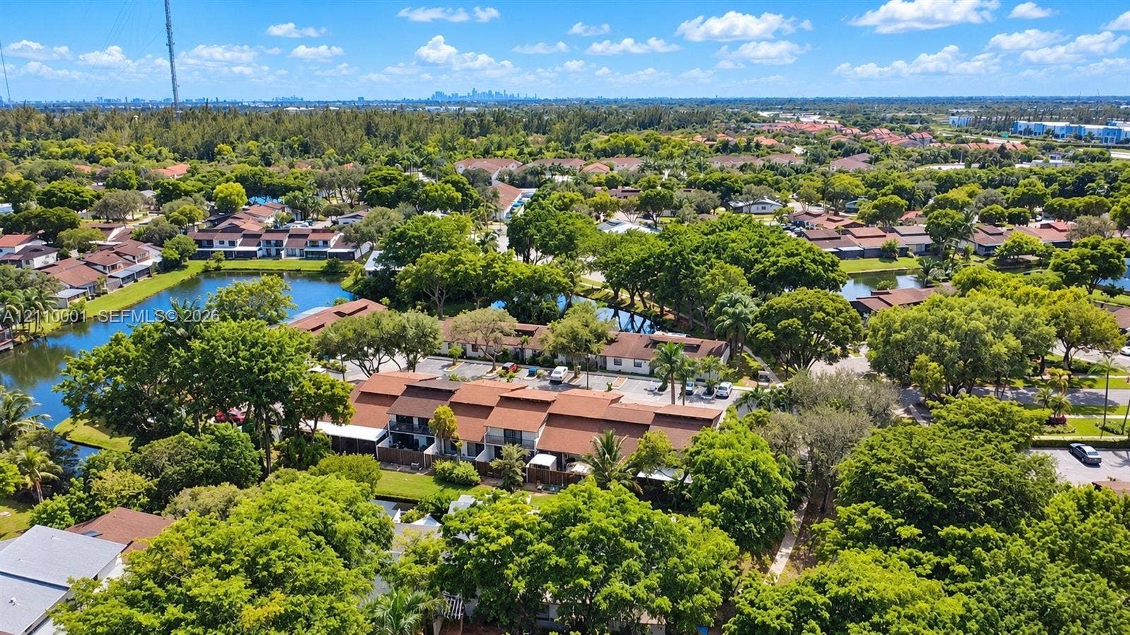 3617 SW 69th Terrace, #24-Z, Miramar, FL 33023 Aerial perspective featuring multi-story residential structures with pitched rooflines, mature tree canopy, and waterfront surroundings