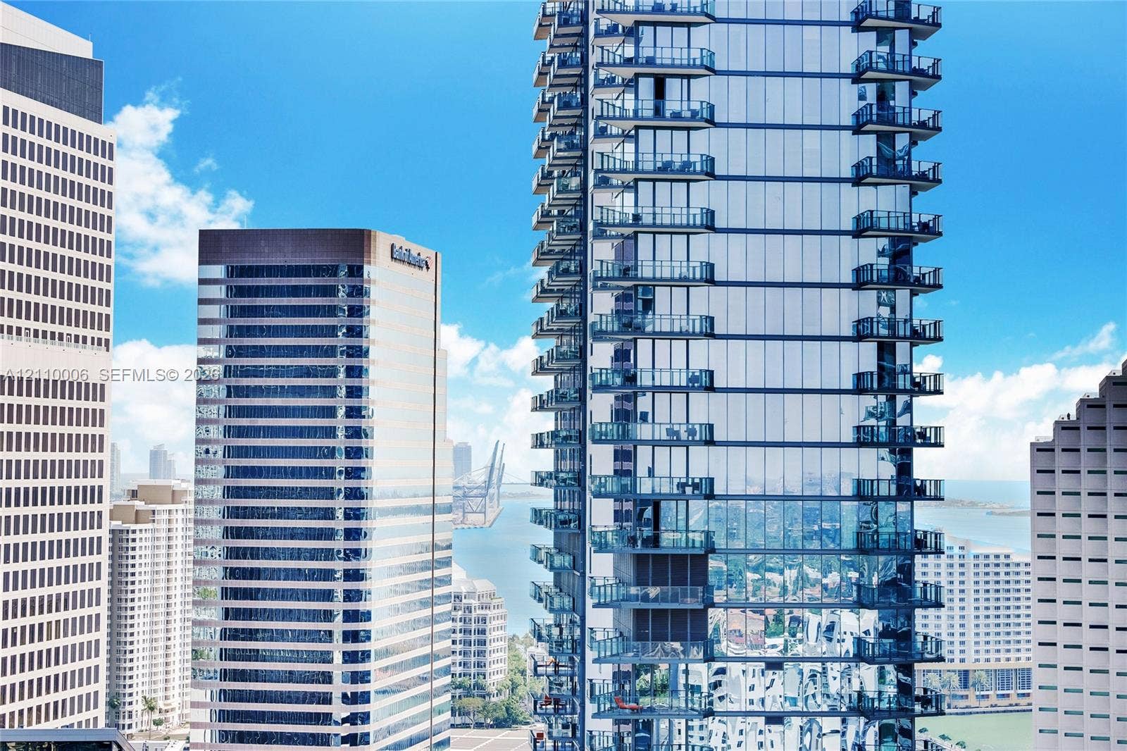 High-rise tower featuring glass curtain wall construction and stacked private balconies