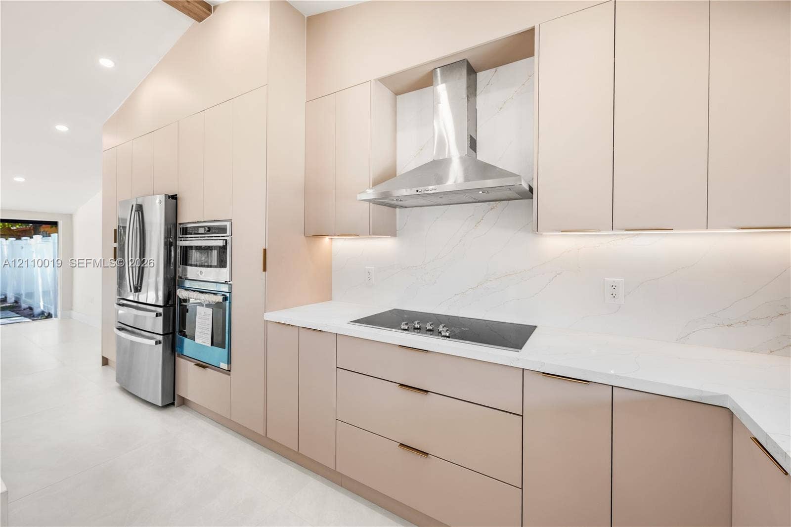 1708 SW 11th Street, Fort Lauderdale, Fort Lauderdale, FL 33312 Custom flat-panel cabinetry, stone-surface countertops, full-height stone backsplash, stainless steel built-in double wall ovens, and stainless steel chimney range hood