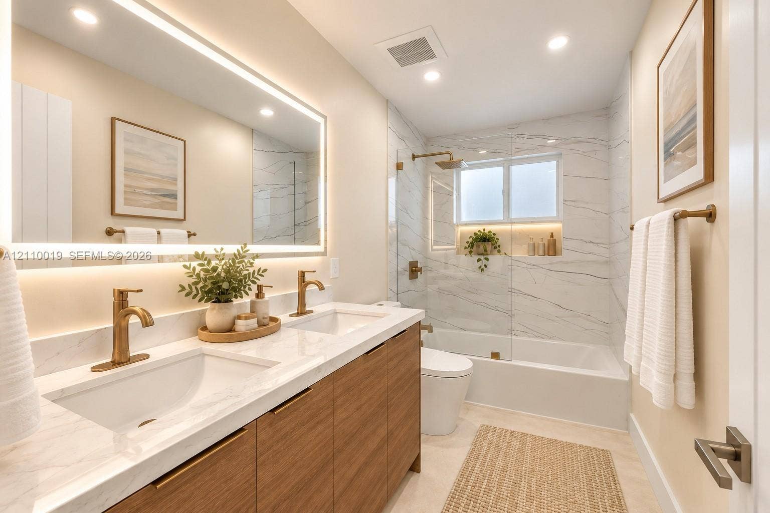 1708 SW 11th Street, Fort Lauderdale, Fort Lauderdale, FL 33312 Dual-sink vanity with wood-finish cabinetry, quartz countertop, recessed lighting, integrated LED-backlit mirror, and brushed gold-tone fixtures