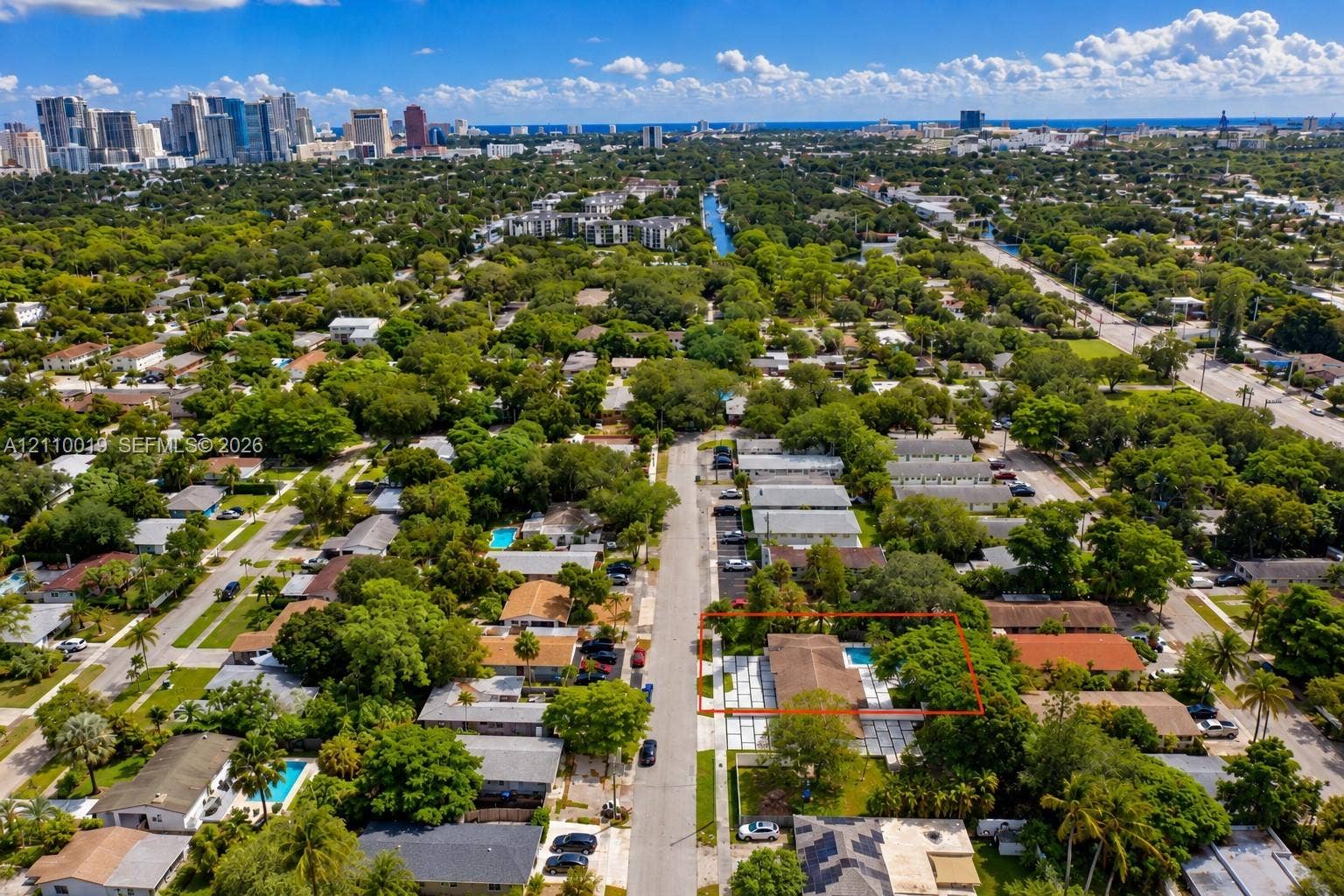 1708 SW 11th Street, Fort Lauderdale, Fort Lauderdale, FL 33312 Aerial perspective of property featuring a rectangular pool, concrete paver patio, and mature trees on the lot