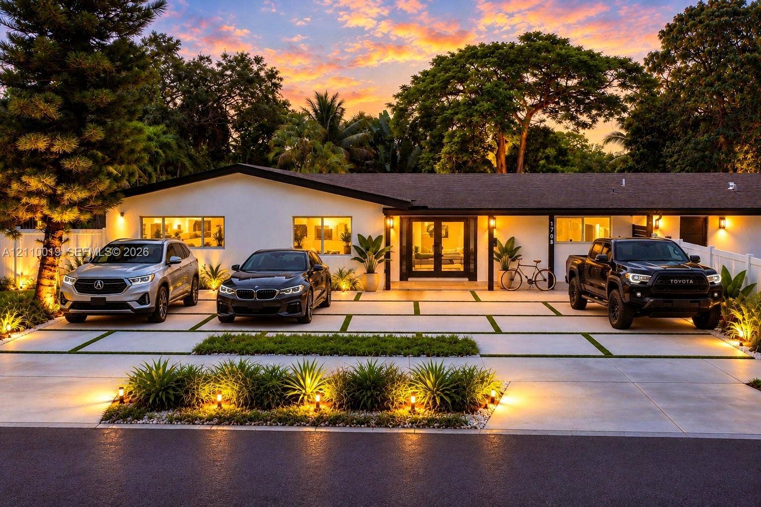 1708 SW 11th Street, Fort Lauderdale, Fort Lauderdale, FL 33312 Single-story residence featuring a low-pitched roofline, light-toned exterior finish, segmented concrete driveway with grass inlays, and mature landscaping