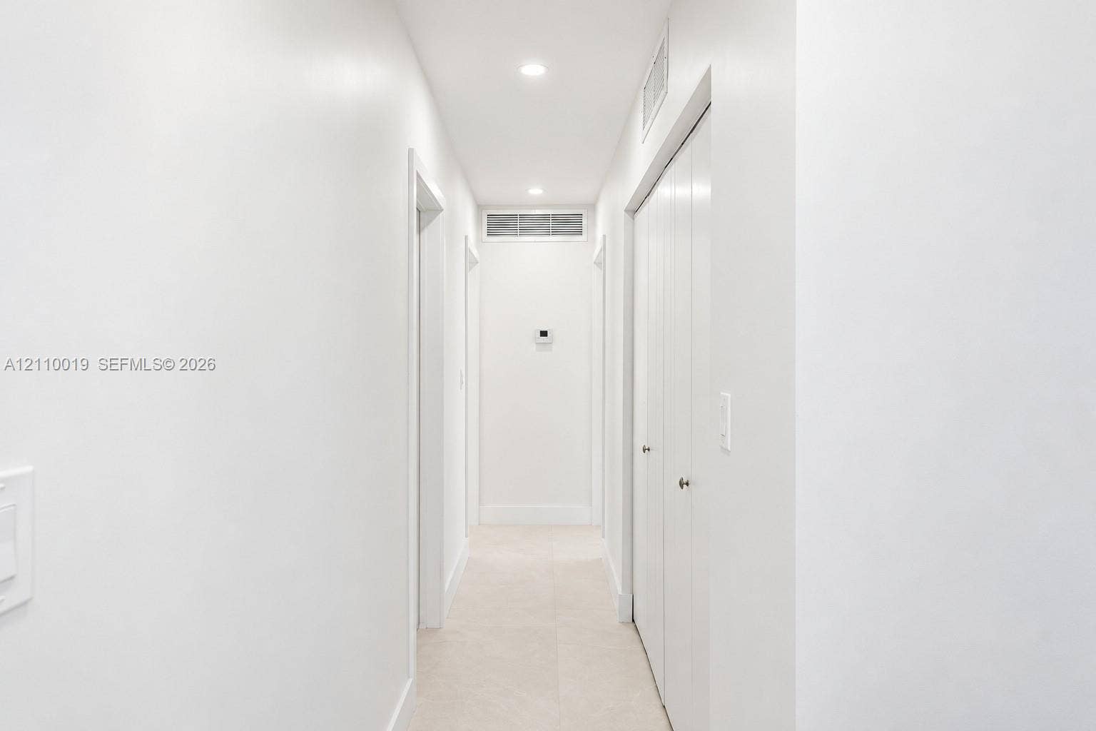 1708 SW 11th Street, Fort Lauderdale, Fort Lauderdale, FL 33312 Hallway featuring neutral tile flooring, recessed lighting, and white bi-fold closet doors