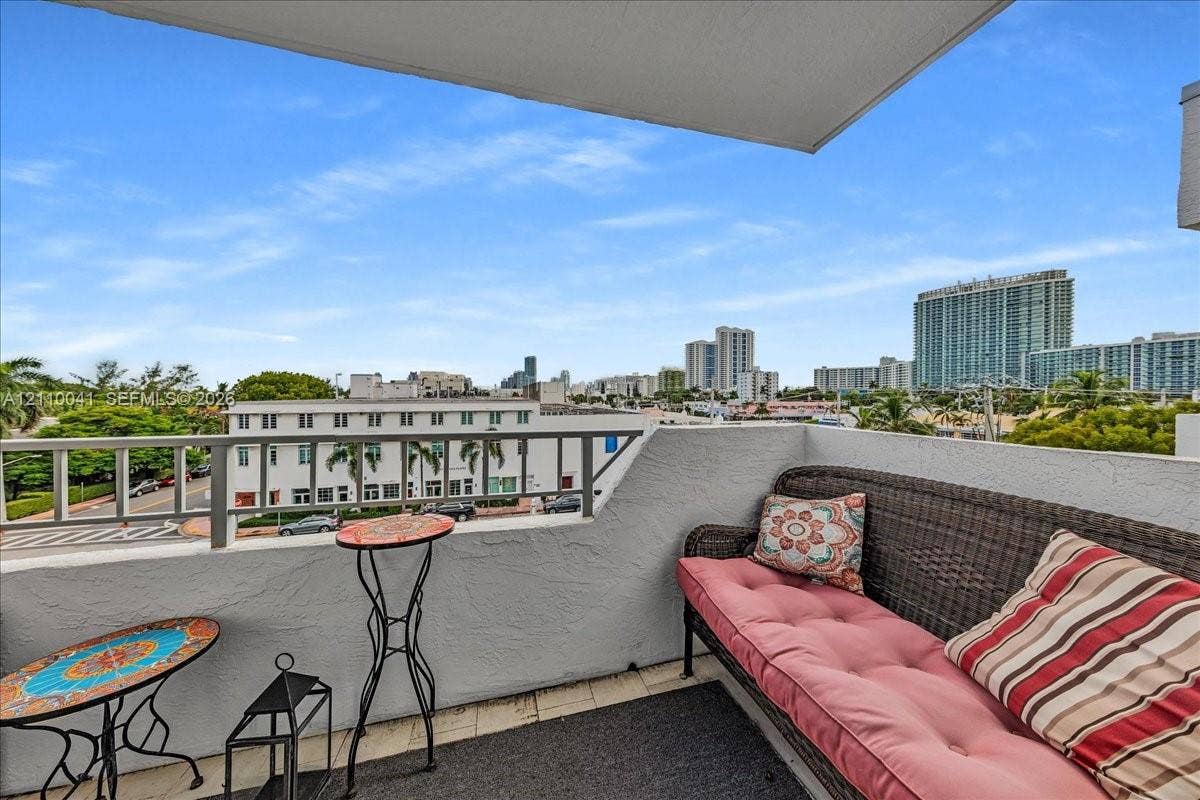 1610 Lenox Avenue, #516, Miami Beach, FL 33139 Private balcony featuring textured stucco walls, metal railings, and tiled flooring with an urban cityscape backdrop
