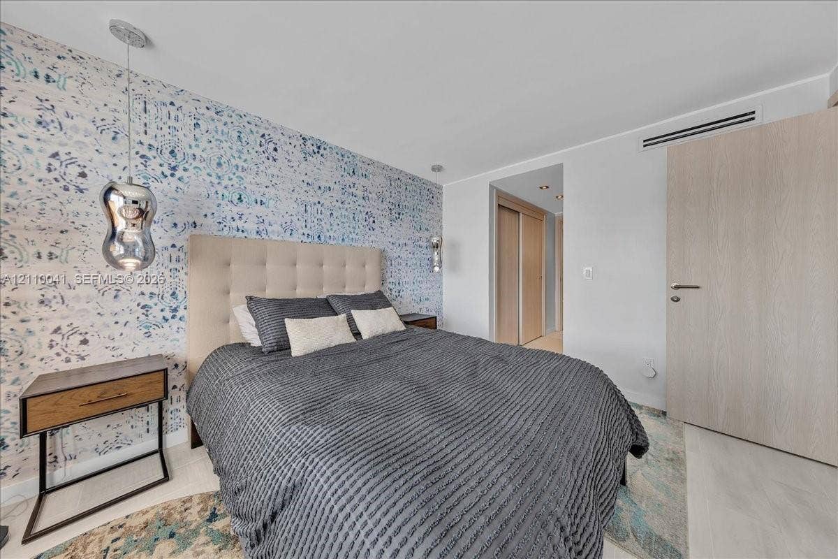 1610 Lenox Avenue, #516, Miami Beach, FL 33139 Patterned accent wallpaper, metallic pendant lighting, wood-finish interior door, and integrated climate control system