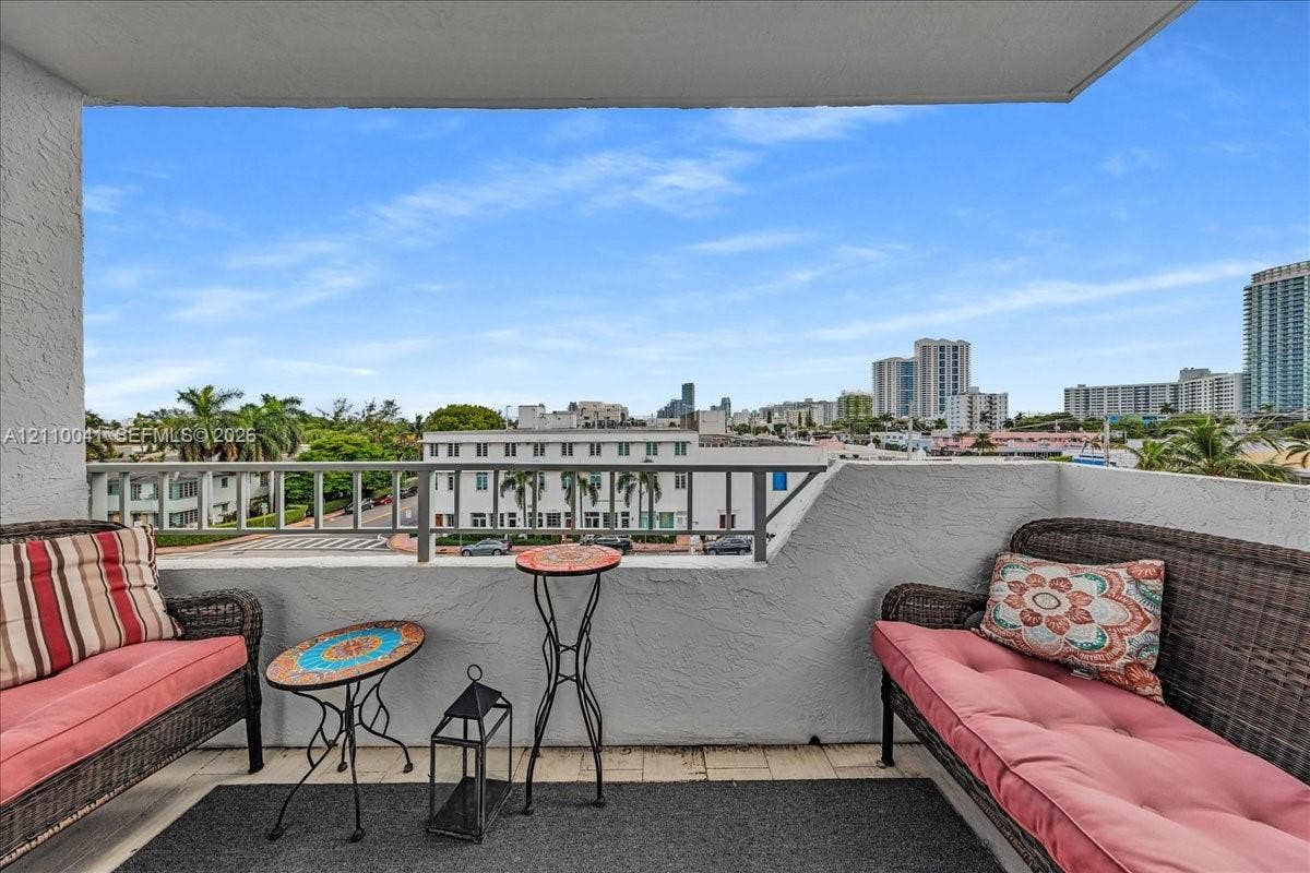 1610 Lenox Avenue, #516, Miami Beach, FL 33139 Covered balcony featuring textured stucco walls, tiled flooring, and a metal railing