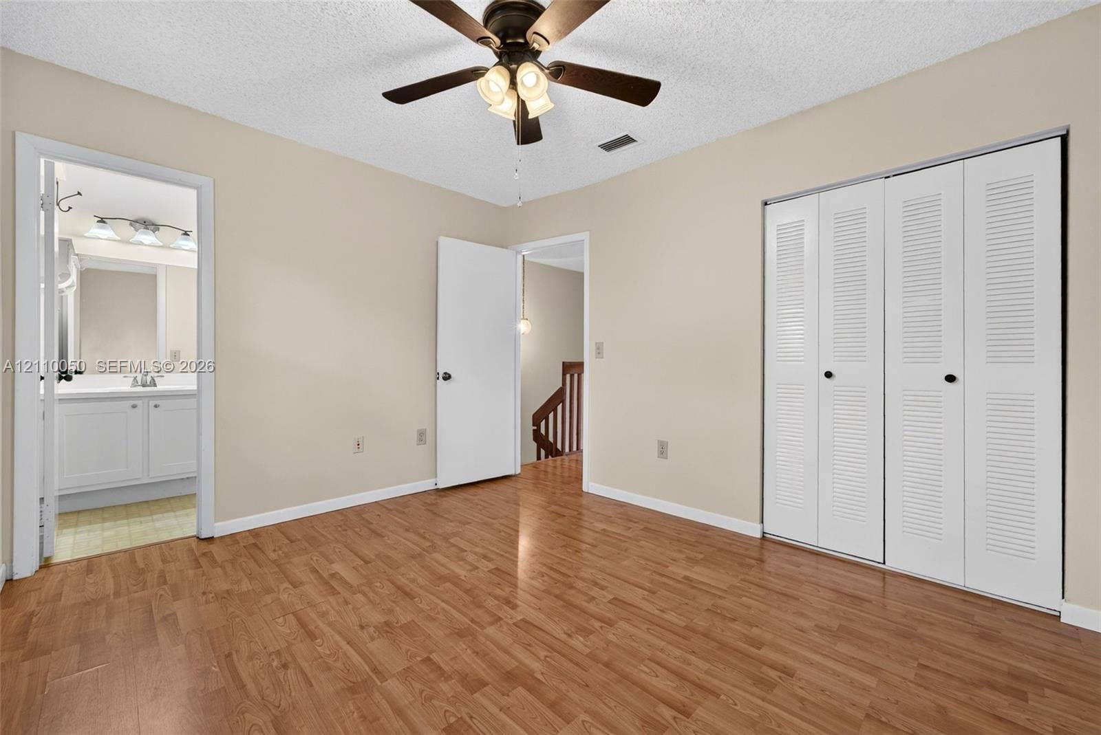 506 Westree Lane, Plantation, Plantation, FL 33324 Room featuring wood-finish flooring, a ceiling fan with integrated lighting, and a closet with white louvered bifold doors