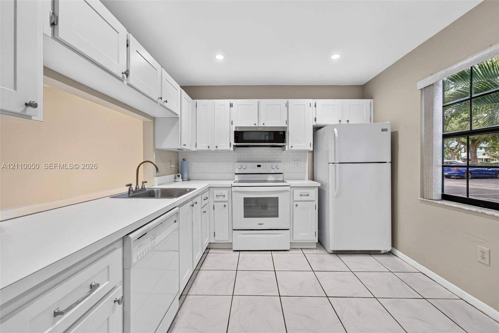 506 Westree Lane, Plantation, Plantation, FL 33324 Kitchen featuring white shaker-style cabinetry, white solid-surface countertops, subway tile backsplash, recessed lighting, and tile flooring