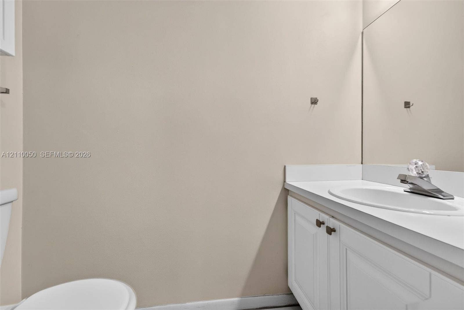 506 Westree Lane, Plantation, Plantation, FL 33324 Vanity featuring a white cabinet base, solid surface countertop, integrated sink, and large wall-mounted mirror
