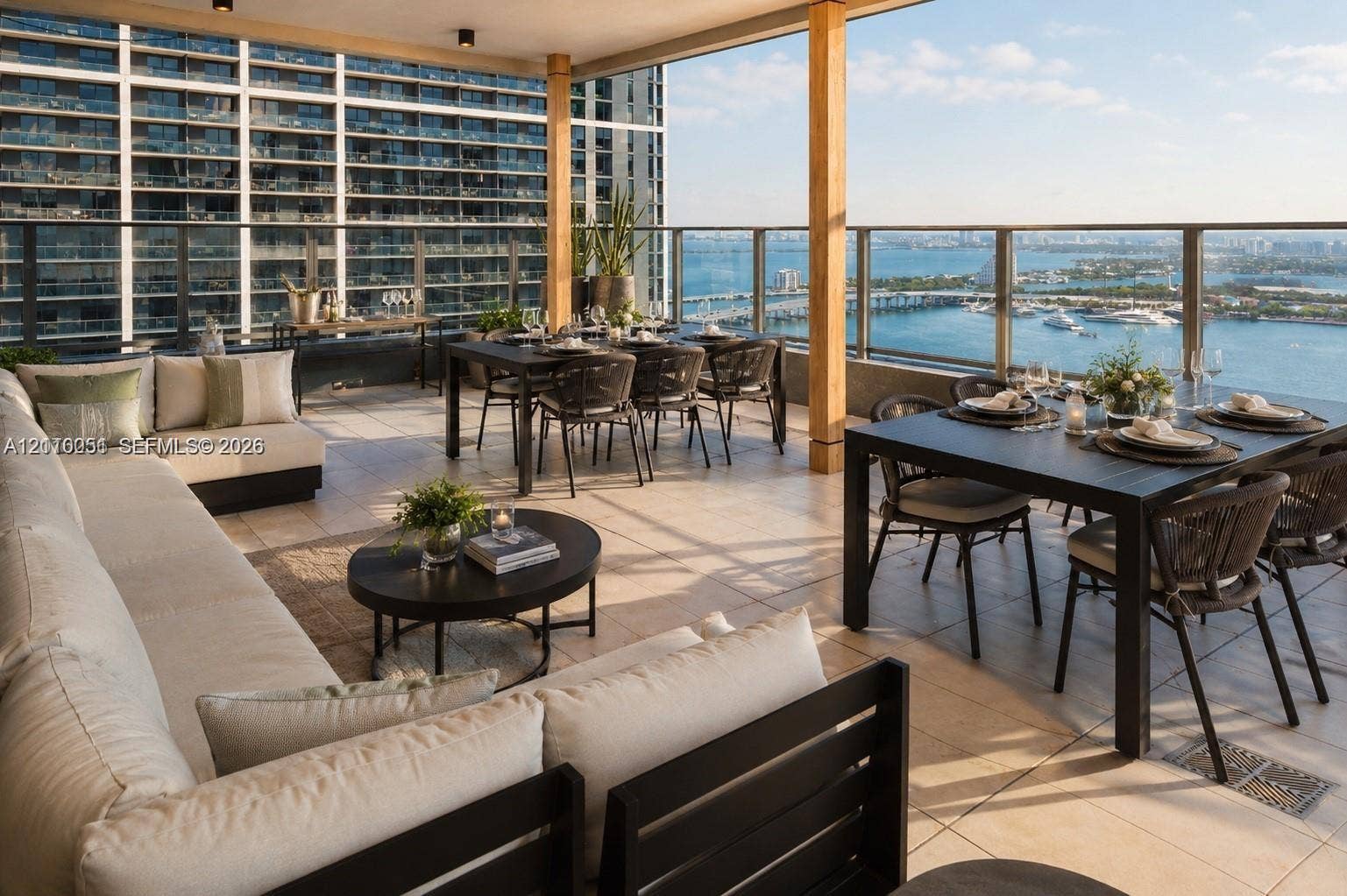 121 NE 5th Street, #1703, Miami, FL 33132 Covered outdoor terrace featuring large-format stone tile flooring, a glass and metal railing system, and recessed overhead lighting