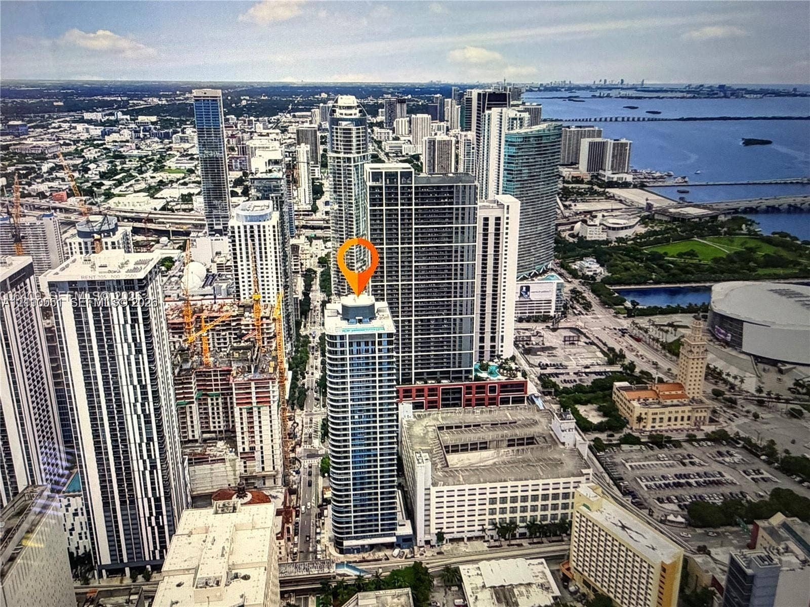 121 NE 5th Street, #1703, Miami, FL 33132 High-rise tower featuring a glass facade, expansive urban scenery, and water frontage