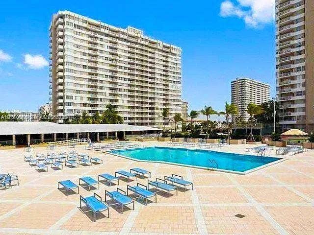 1950 S Ocean Drive, #3K, Hallandale Beach, Hallandale Beach, FL 33009 Swimming pool with a tile-paved deck and tropical landscaping