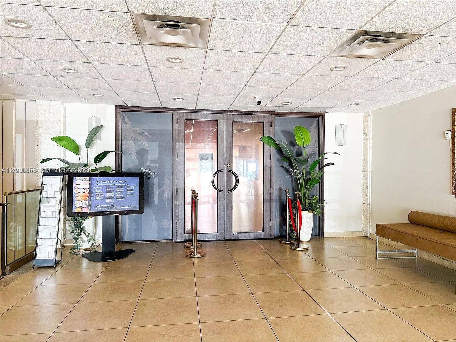 1950 S Ocean Drive, #3K, Hallandale Beach, Hallandale Beach, FL 33009 Lobby entrance featuring large glass-paneled double doors, recessed ceiling lighting, and tile flooring