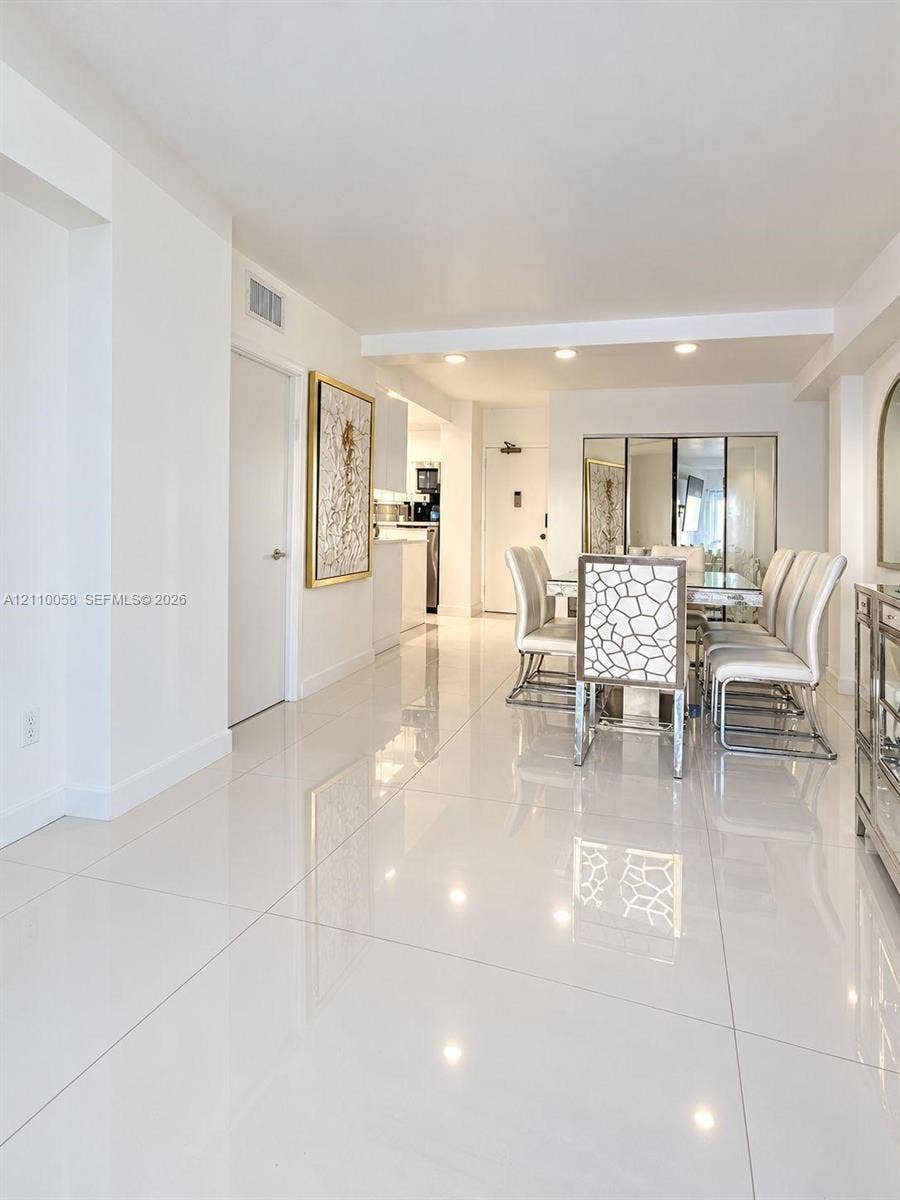 1950 S Ocean Drive, #3K, Hallandale Beach, Hallandale Beach, FL 33009 Large-format polished tile flooring, recessed ceiling lighting, and mirrored wall accents