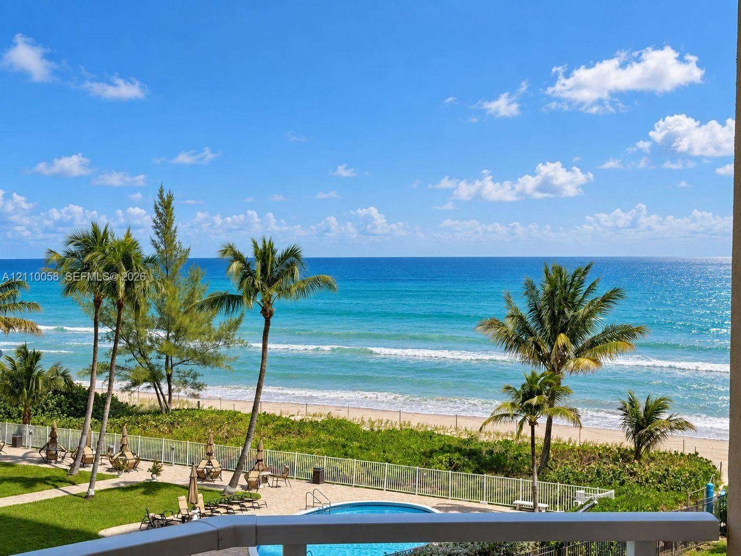 1950 S Ocean Drive, #3K, Hallandale Beach, Hallandale Beach, FL 33009 Private balcony overlooking a swimming pool, manicured lawn, sandy beach, and oceanfront horizon