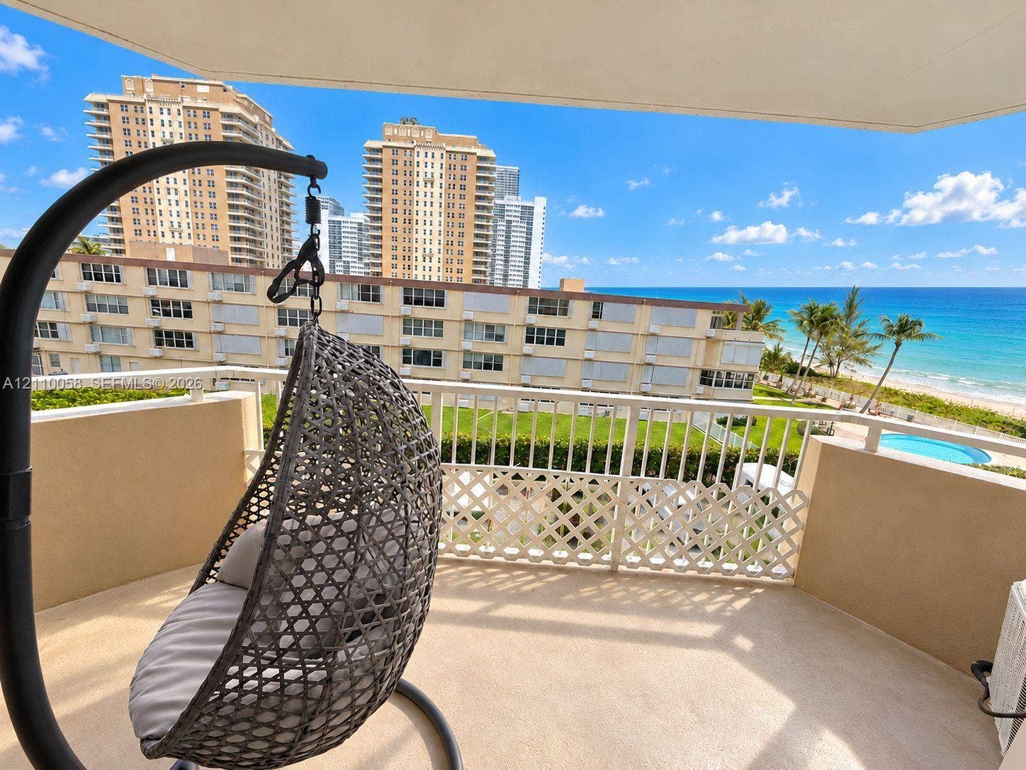 1950 S Ocean Drive, #3K, Hallandale Beach, Hallandale Beach, FL 33009 Private balcony featuring a textured concrete floor, white metal railing, and direct sightlines to the ocean and coastline