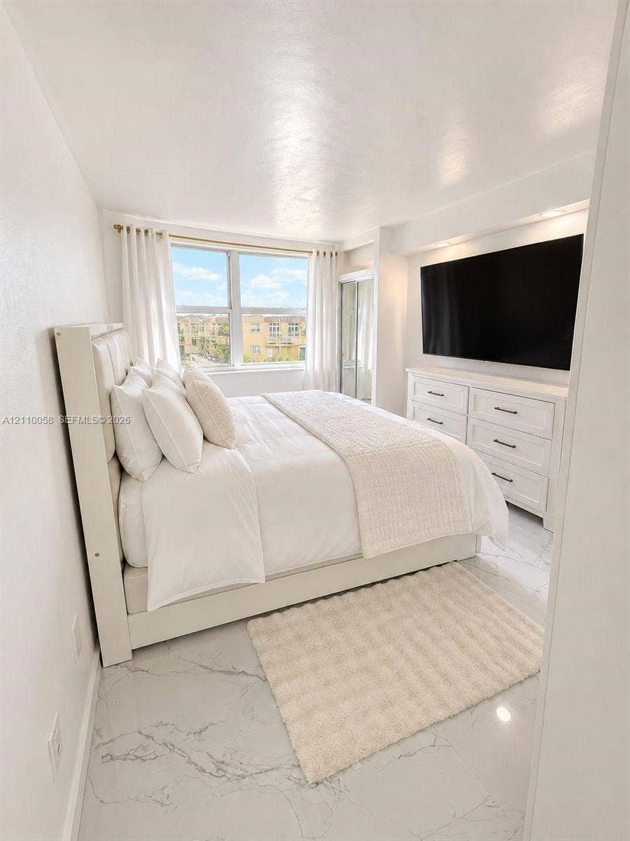 1950 S Ocean Drive, #3K, Hallandale Beach, Hallandale Beach, FL 33009 Neutral-toned room featuring large-format stone-finish flooring, recessed lighting, and a window with exterior exposure