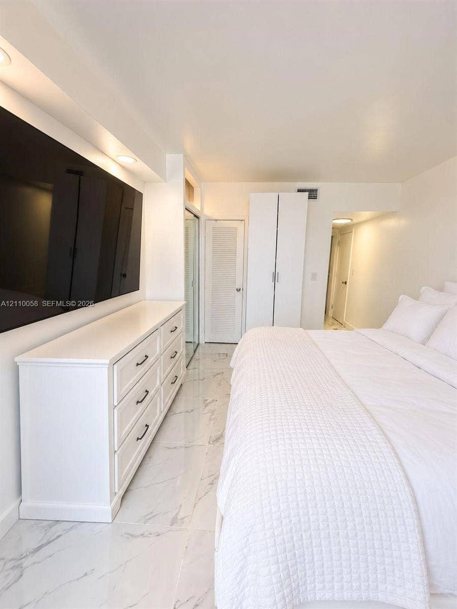 1950 S Ocean Drive, #3K, Hallandale Beach, Hallandale Beach, FL 33009 Polished stone-finish flooring, built-in recessed ceiling lighting, louvered closet door, and full-height wardrobe cabinetry