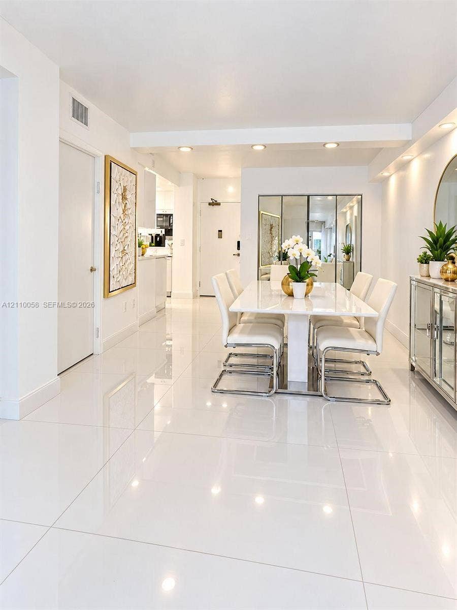 1950 S Ocean Drive, #3K, Hallandale Beach, Hallandale Beach, FL 33009 Polished white tile flooring, recessed ceiling lighting, and mirrored wall accents