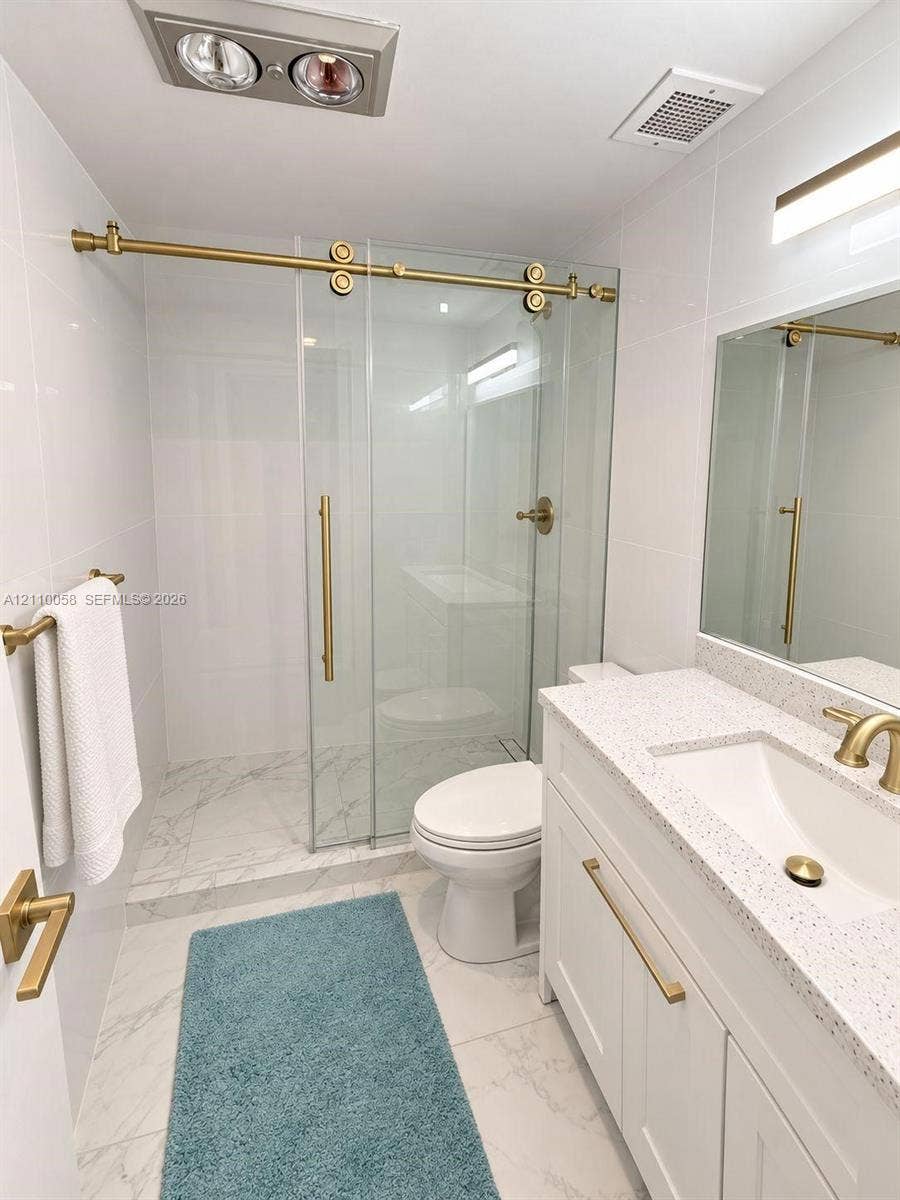 1950 S Ocean Drive, #3K, Hallandale Beach, Hallandale Beach, FL 33009 Bathroom featuring a white vanity with a speckled countertop, integrated sink, and brass-tone hardware