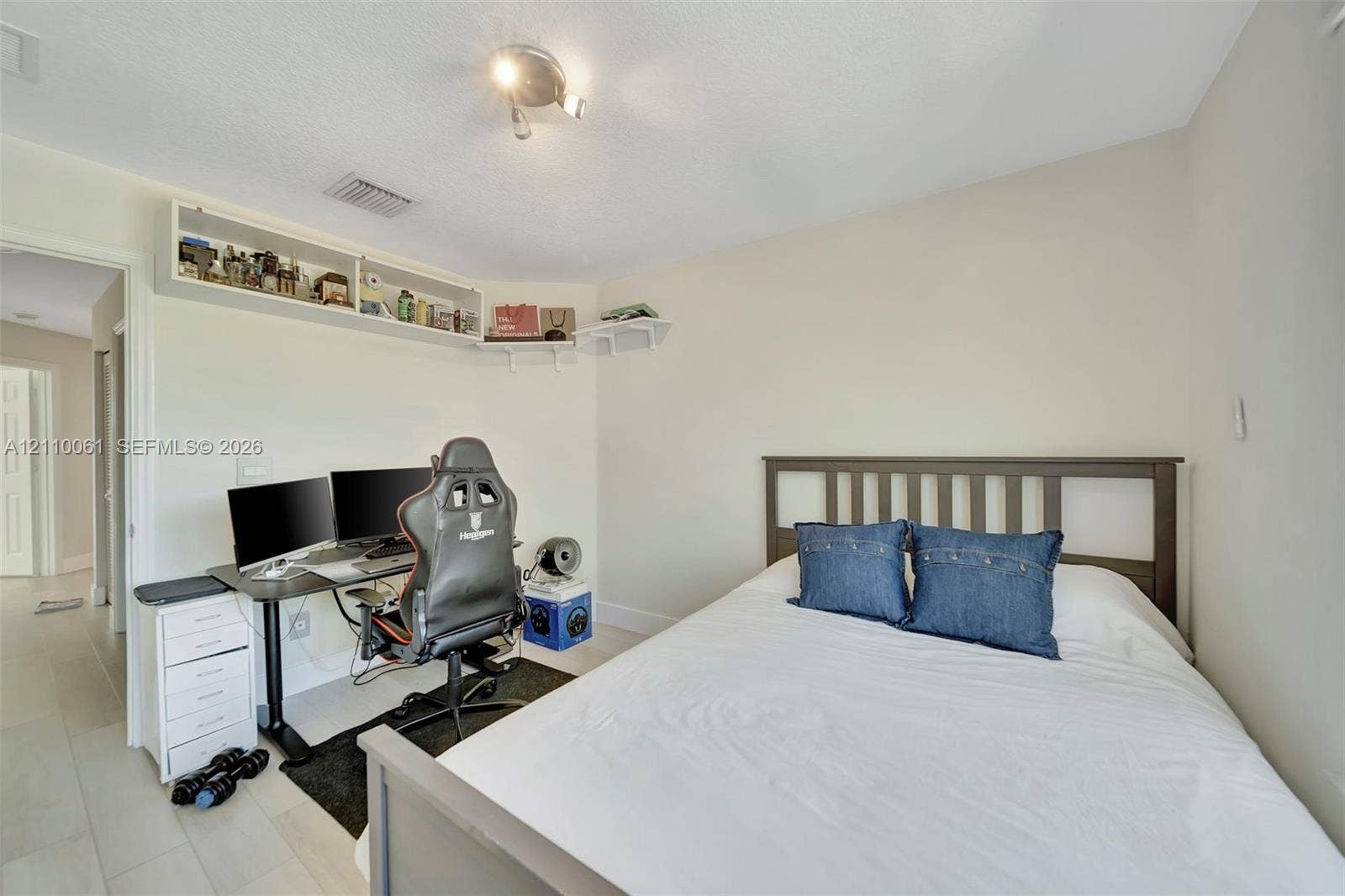 4424 E Whitewater Avenue, Weston, FL 33332 Neutral-toned room featuring light-colored flooring and built-in white corner shelving