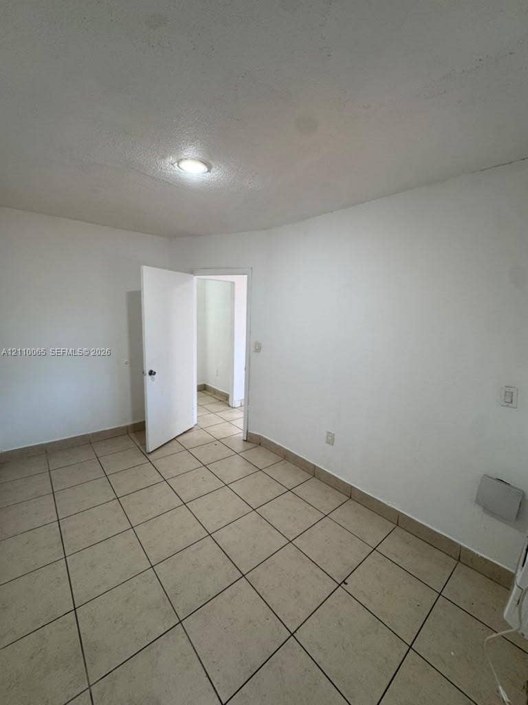 1701 NW 27th Avenue, #14, Miami, Miami, FL 33125 Neutral-toned tile flooring, white interior walls, and a recessed ceiling lighting fixture