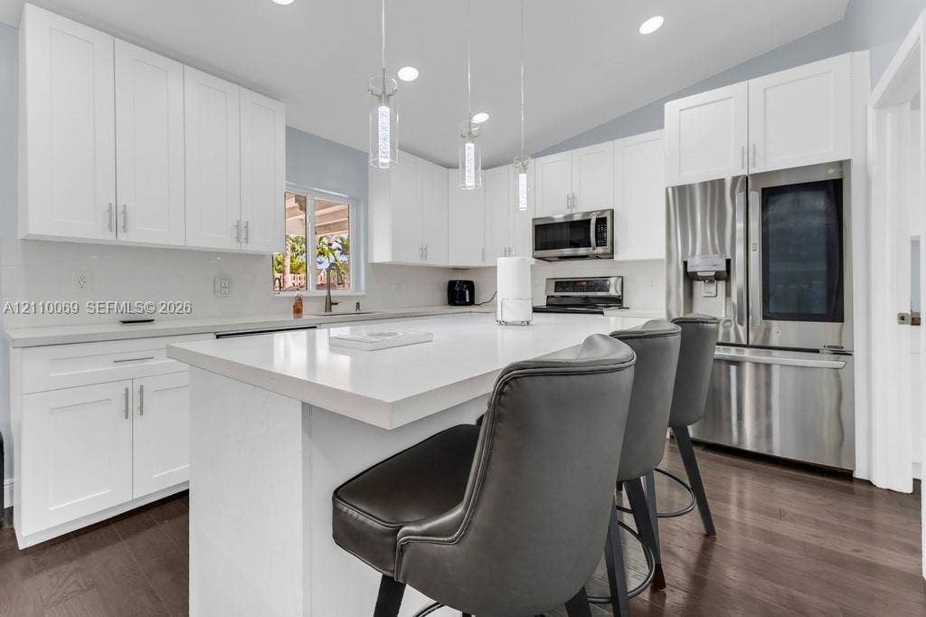 4325 NW 95th Terrace, Sunrise, FL 33351 Kitchen featuring white cabinetry, quartz countertops, a central island, recessed lighting, and stainless steel appliances