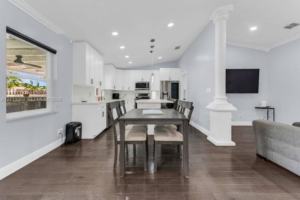 4325 NW 95th Terrace, Sunrise, FL 33351 Open-concept kitchen featuring white shaker-style cabinetry, quartz countertops, a central island, recessed lighting, and dark wood-finish flooring