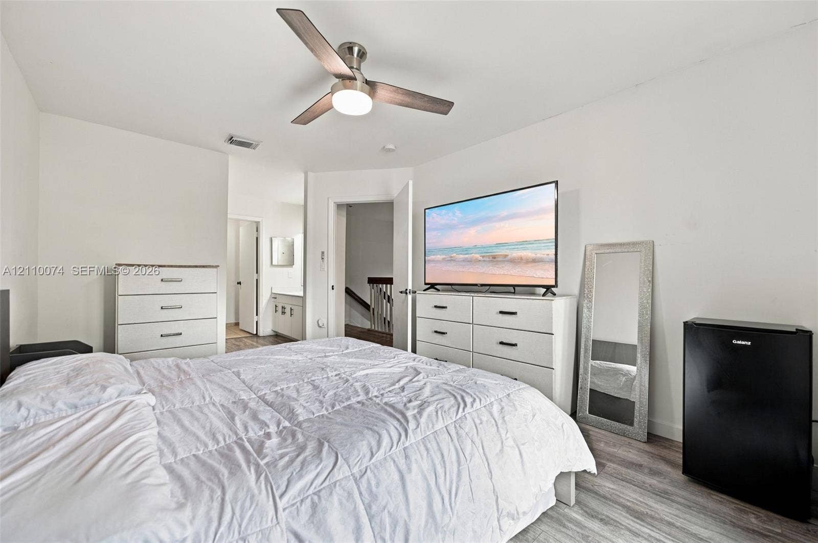 17370 NW 69th Court, #304, Hialeah, FL 33015 Wood-finish flooring and a central ceiling fan with an integrated light fixture